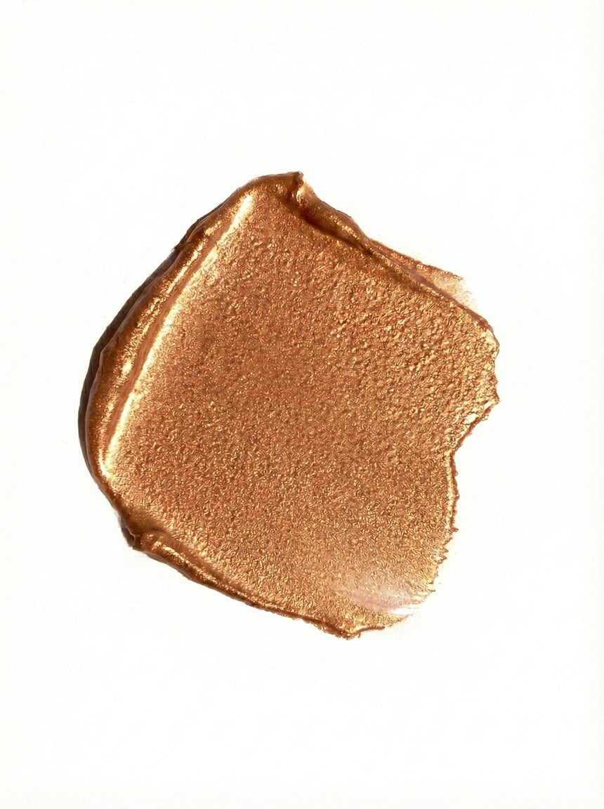 Bronze-colored makeup swatch on a white background