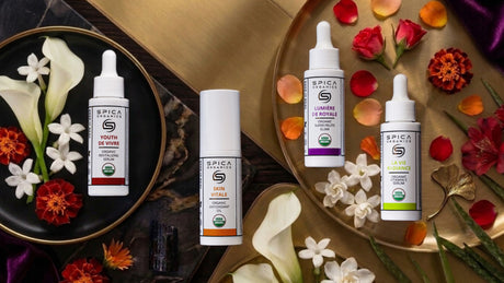 Spica Organics pure organic skincare products on a luxury dark flat-lay display with red, orange, white botanical accents