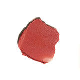 Close-up of a swatch of red lipstick on a white background