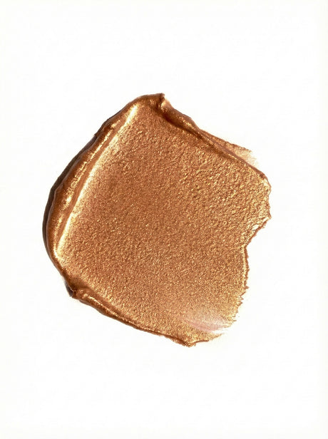 Bronze-colored makeup swatch on a white background