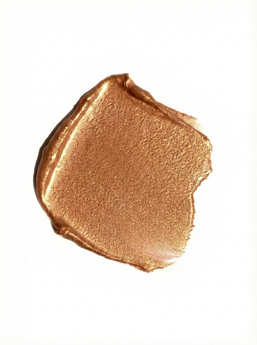 Bronze-colored makeup swatch on a white background
