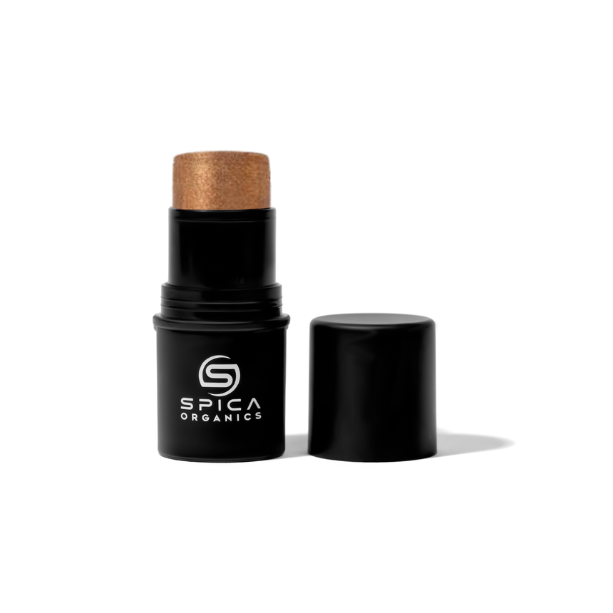 Black cosmetic stick with gold cap on a white background, branded as Spica Organics.