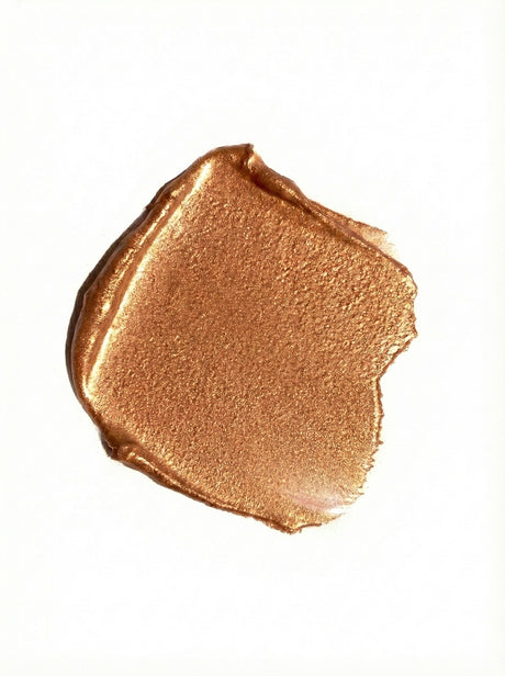 Bronze-colored makeup swatch on a white background
